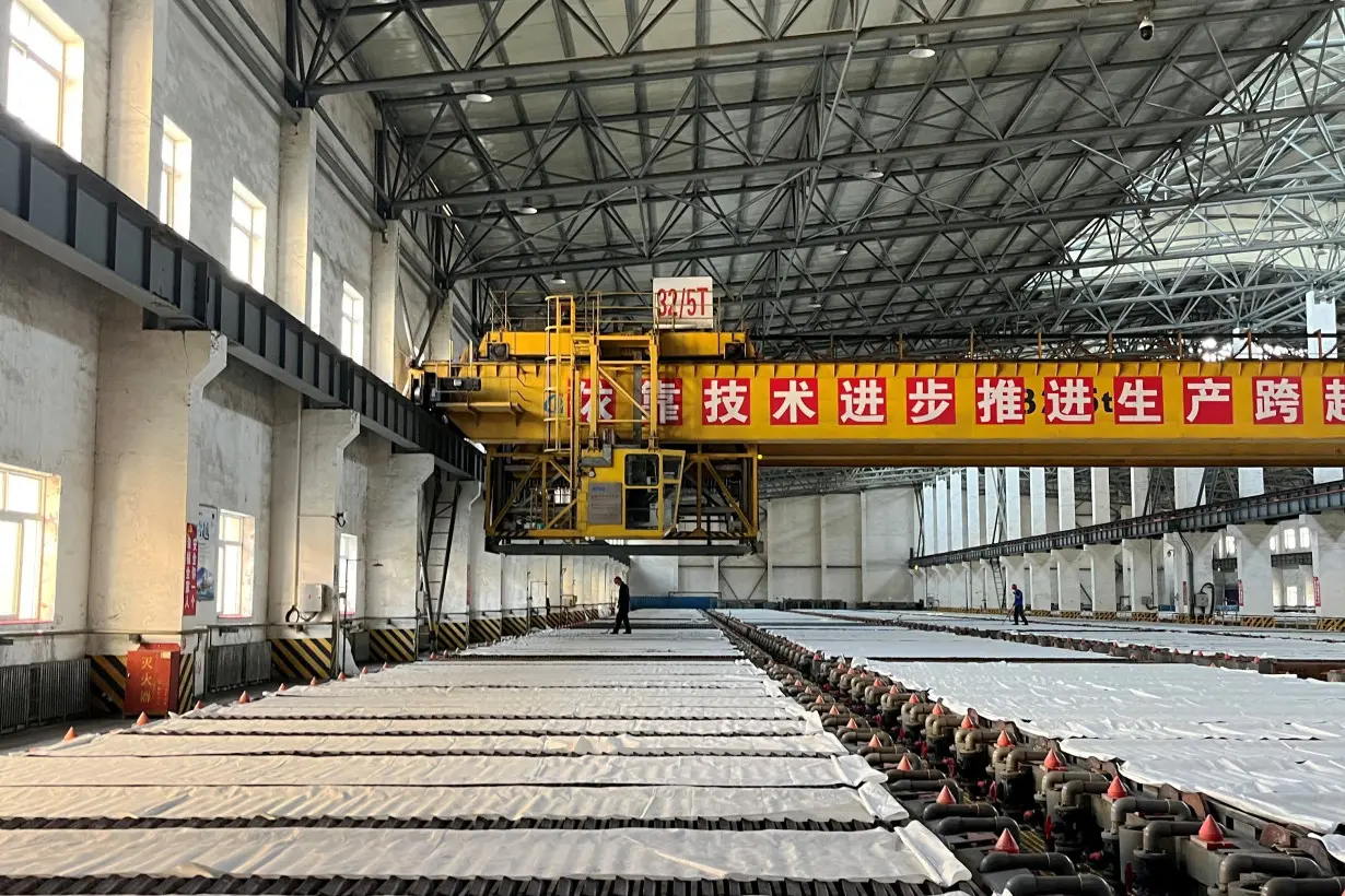 FILE PHOTO: Employees work at a copper smelter in Yantai