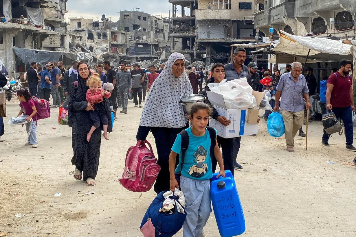 Displaced Palestinians flee areas in northern Gaza Strip following an Israeli evacuation order, in Gaza