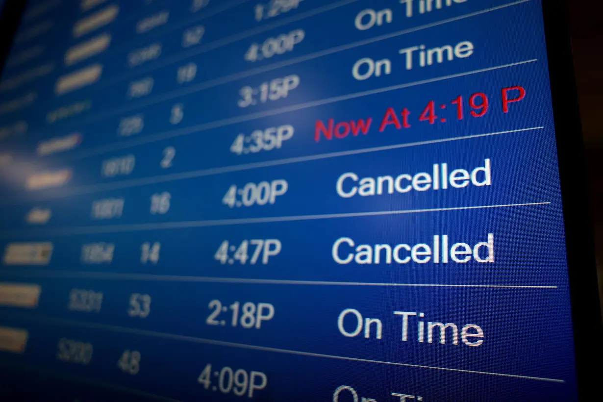 A flight information display system shows departure times at the Ronald Reagan Washington National Airport on December 27, 2021 in Arlington, Virginia.