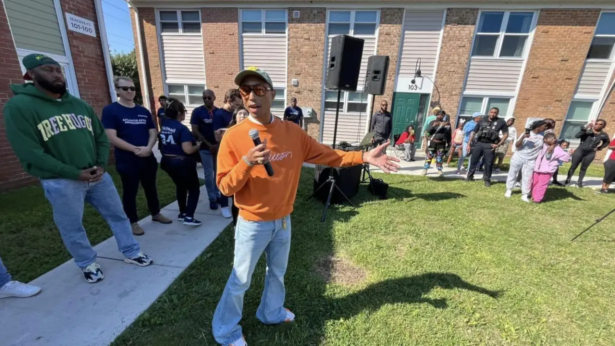 Pharrell makes surprise stop at LEGO and sneaker giveaway in former neighborhood