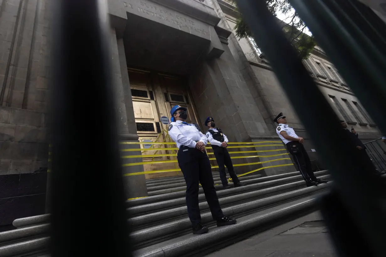 Law enforcement officers guard the main entrance of the Supreme Court of Justice (SCJN) after judges decided to join the work stoppage due to a debate in Congress on a controversial judicial reform in Mexico City