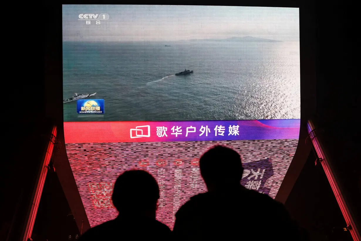 Screen shows news footage of military drills conducted in areas around the island of Taiwan by the Eastern Theatre Command of the Chinese PLA, in Beijing