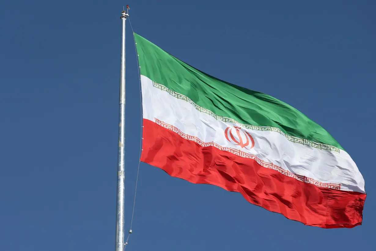 The Iranian flag is seen flying over a street in Tehran