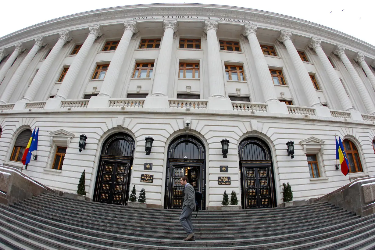 A man walks in front of Romania's Central Bank headquarters during a news conference of the International Monetary Fund (IMF)'s Romania mission in Bucharest