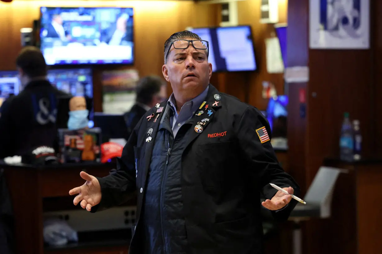 FILE PHOTO: Traders work on the floor of the NYSE in New York