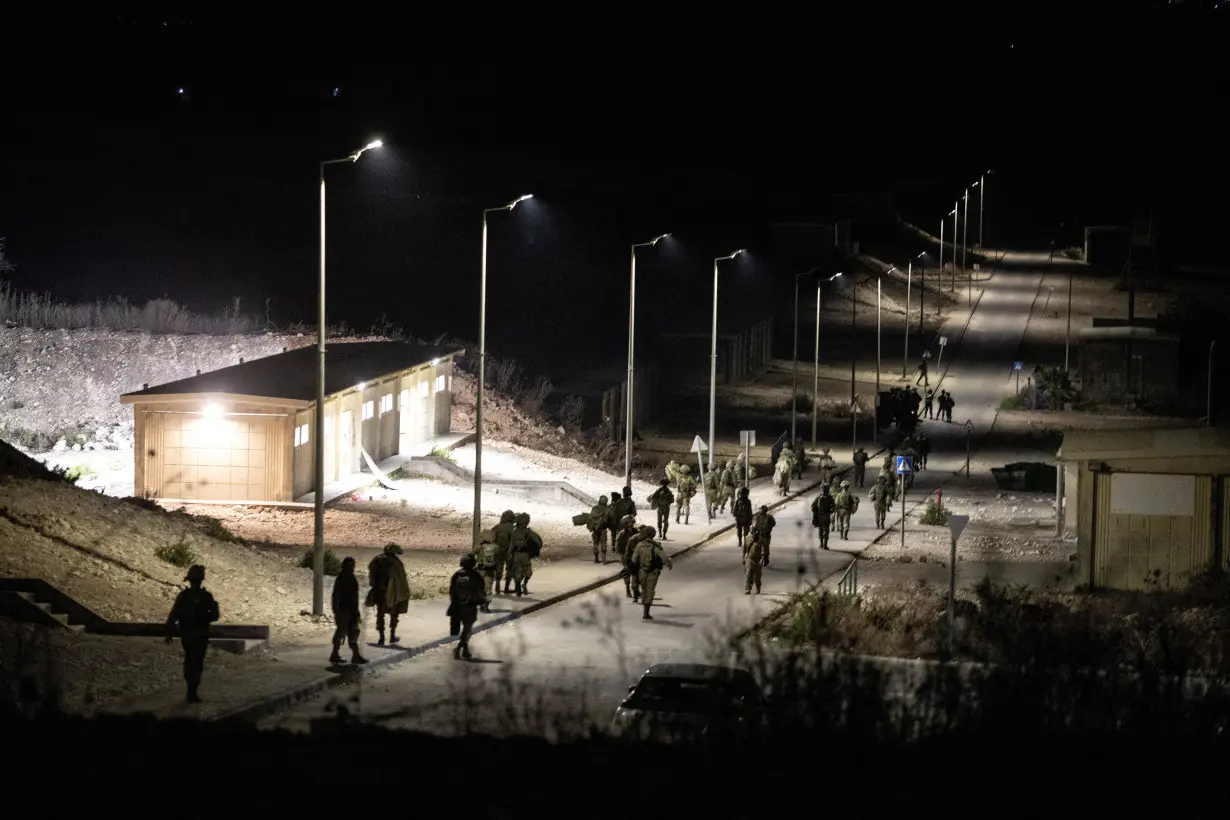 FILE PHOTO: Israeli soldiers walk near the scene where a drone from Lebanon attacked Israel in Binyamina