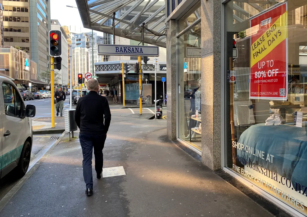 A man walks past stores at the main shopping district, in Wellington