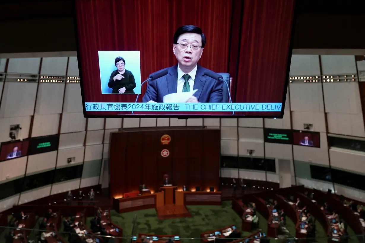 Hong Kong Chief Executive John Lee is seen on a screen as he delivers his annual policy address at the Legislative Council in Hong Kong