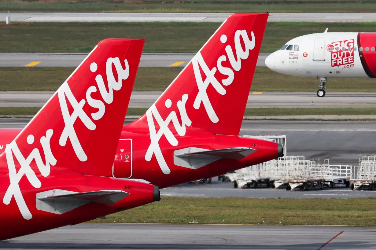 FILE PHOTO: Planes from AirAsia, a subsidiary airline of Capital A, are seen on the tarmac of Kuala Lumpur International Airport Terminal 2 (KLIA2) in Sepang