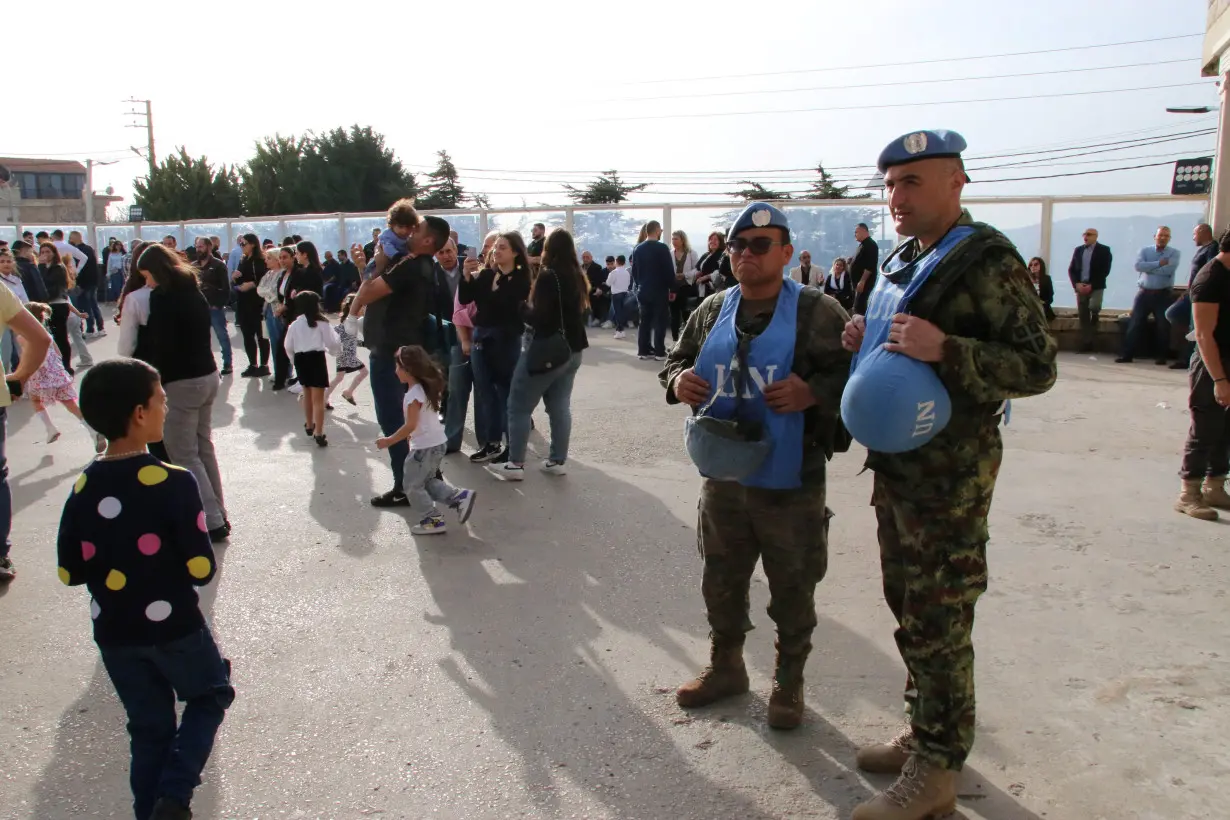 Members of the United Nations peacekeepers (UNIFIL) stand together at the church square on Good Friday in the town of Klayaa