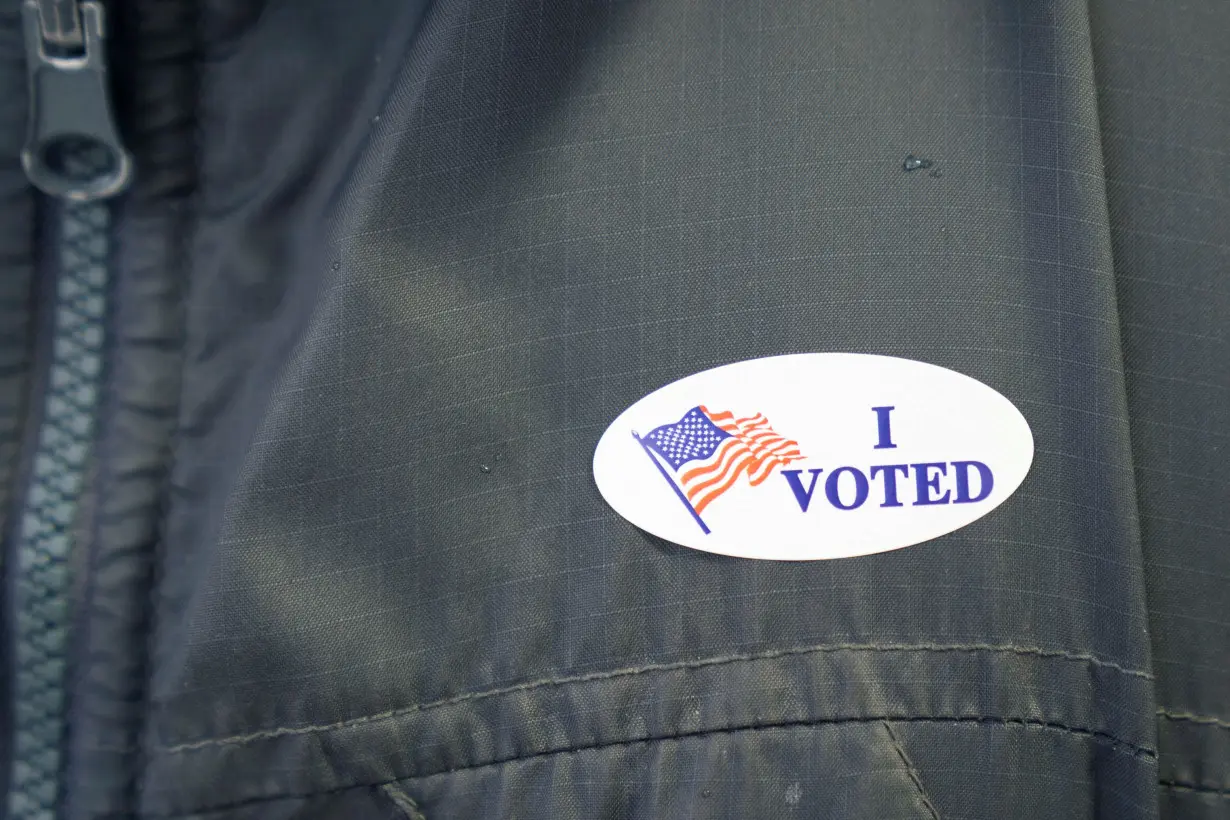 A file photo of a voter wearing an 'I voted' sticker at a polling station