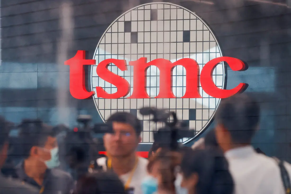 Taiwan Semiconductor Manufacturing Company's (TSMC) logo is seen while people attend the opening of the TSMC global R&D center in Hsinchu