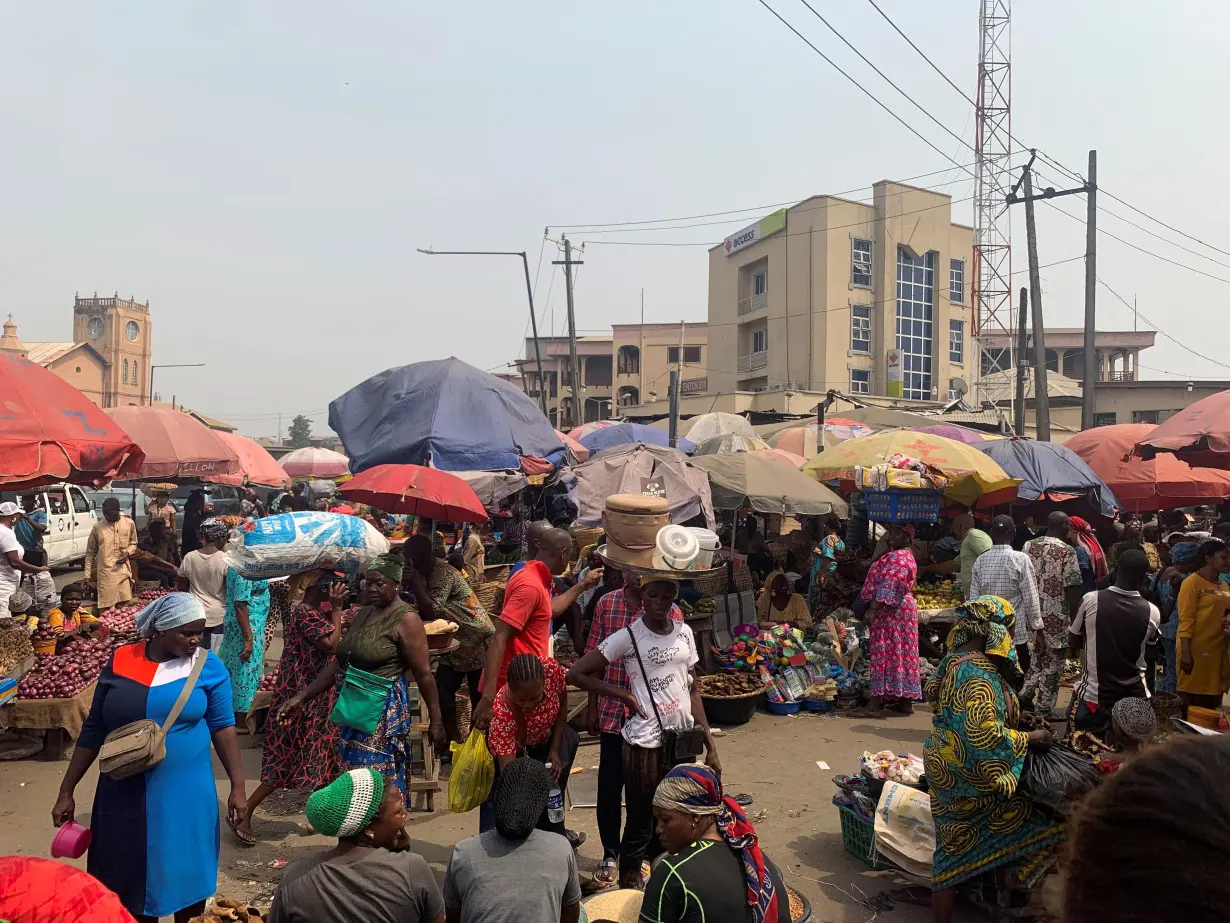 People shop at a fresh food market in Oyingbo, Lagos