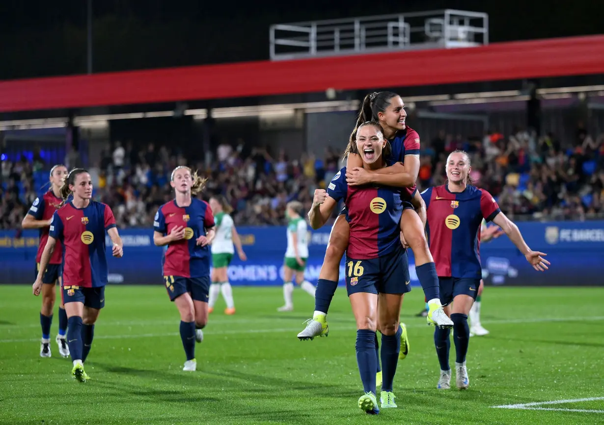 Fridolina Rolfö celebrates with teammate Kika Nazareth after scoring Barcelona's ninth goal from a penalty kick.