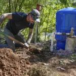 After hurricane, with no running water, residents organize to meet a basic need