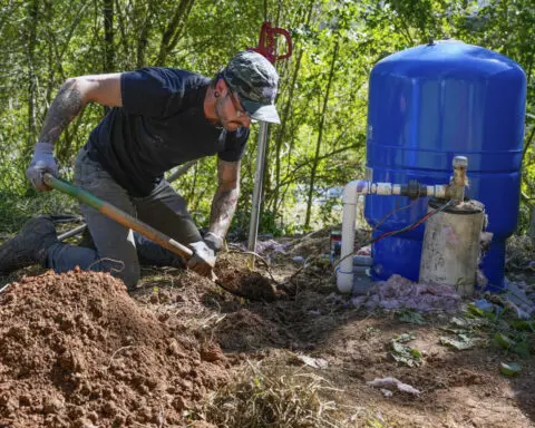 After hurricane, with no running water, residents organize to meet a basic need