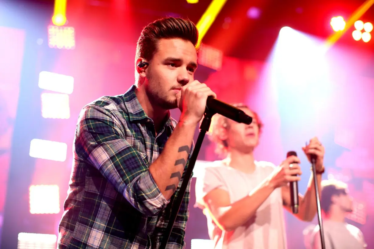 Liam Payne performing on stage with One Direction.