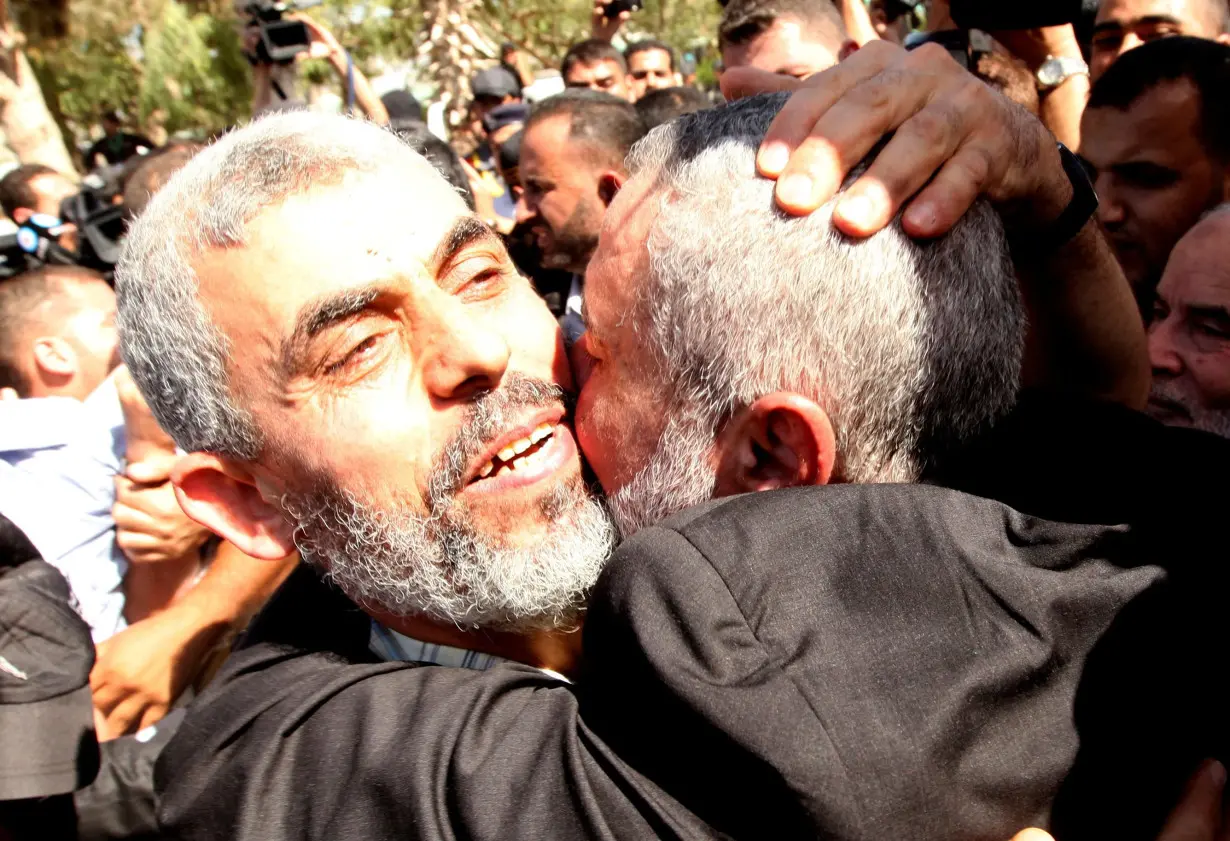 FILE PHOTO: Freed Hamas top security strategist Al-Sinwar is hugged by senior Hamas leader Haniyeh upon his arrival at the Rafah crossing in the Gaza Strip