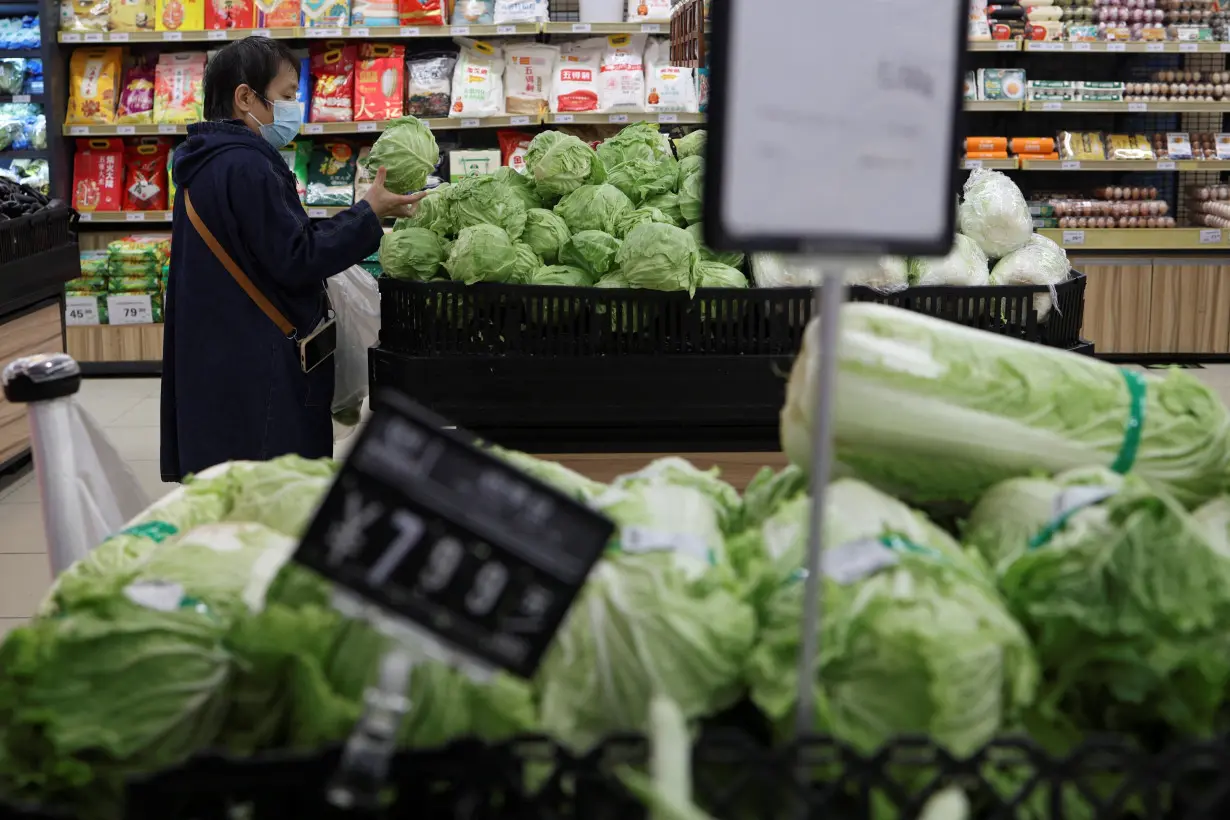 Customer shops at a supermarket in Beijing