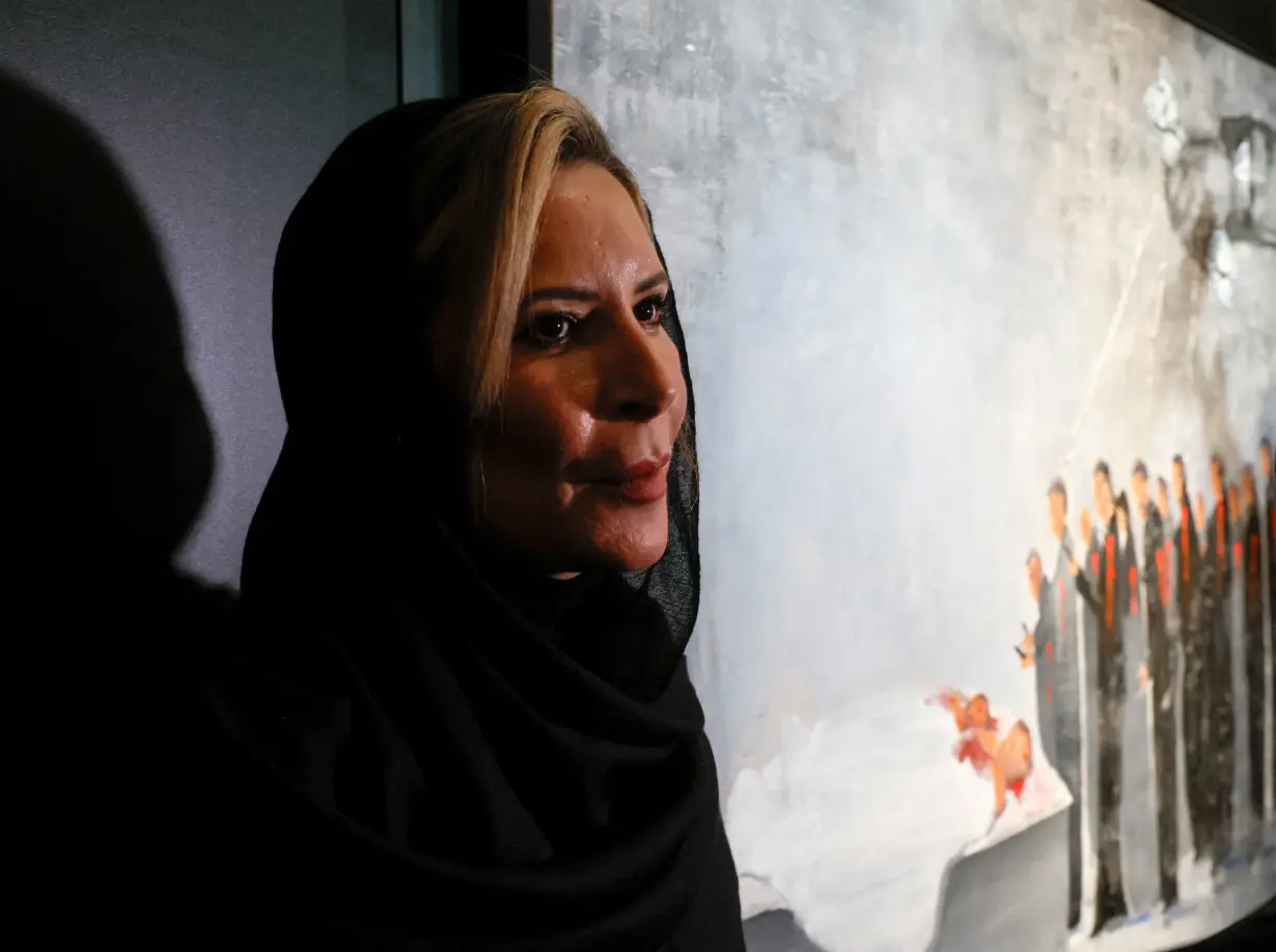 Aisha Gaddafi, daughter of Libya's former leader Muammar Gaddafi, attends an exhibition of her artworks in Moscow