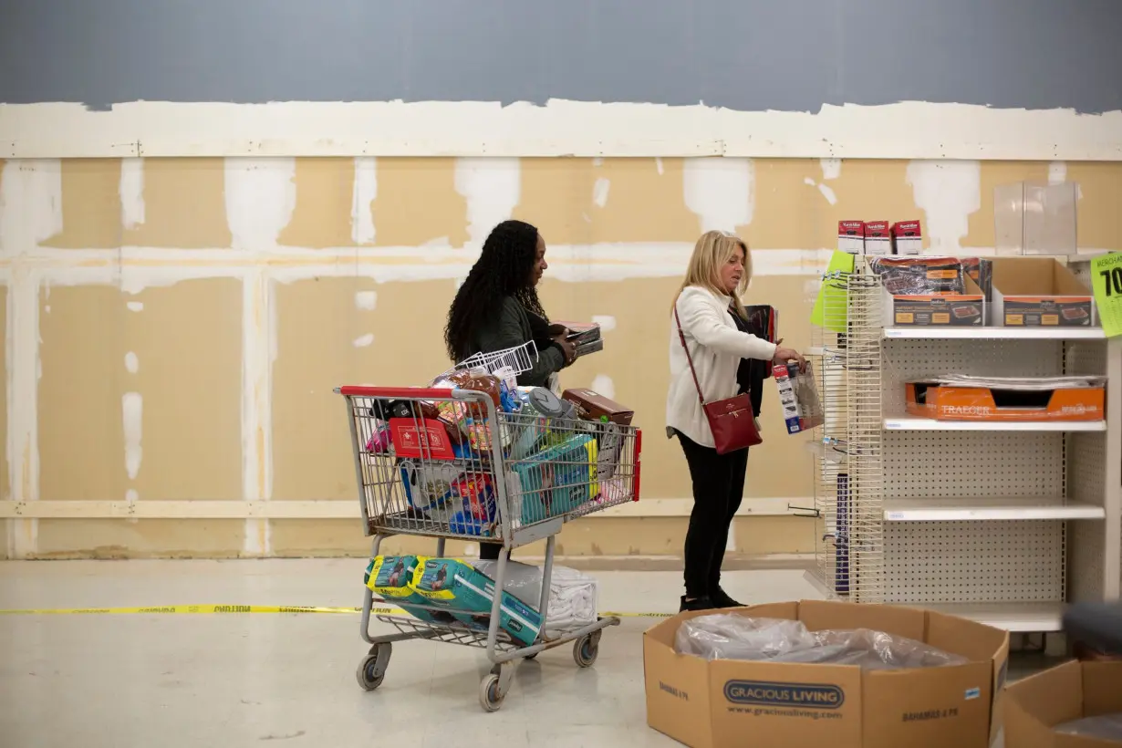 Shahlise Cherry and her friend Deborah Arnone continue to pick through the quickly emptying shelves of the Kmart in Bridgehampton, New York.