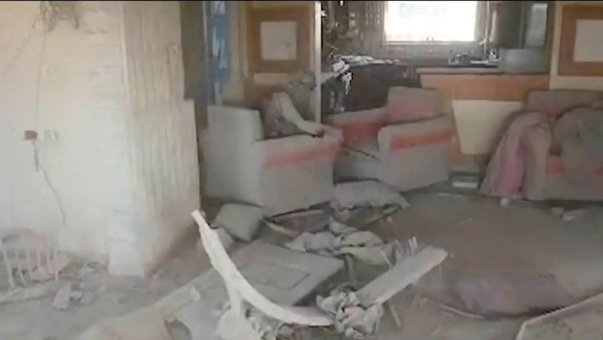 This still image from video provided by the Israel Defense Forces shows a damaged building where a person – who the IDF says is Sinwar – is seen. The man's face is obscured and he is seen sitting alone in Rafah, Gaza Strip, on Wednesday, October 16.