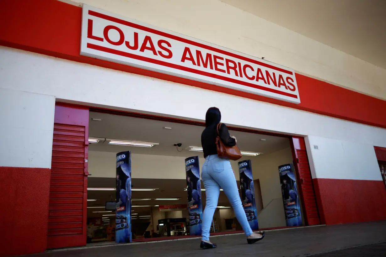 A woman walks in front of a Lojas Americanas store in Brasilia