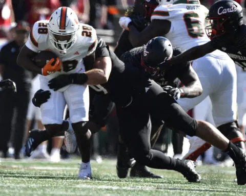 Cam Ward throws for 4 touchdowns, No. 6 Miami survives Louisville comeback bids for wild 52-45 win