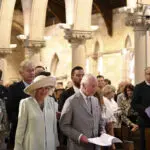 Children greet King Charles III and Queen Camilla outside a Sydney church