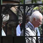 Children greet King Charles III and Queen Camilla outside a Sydney church