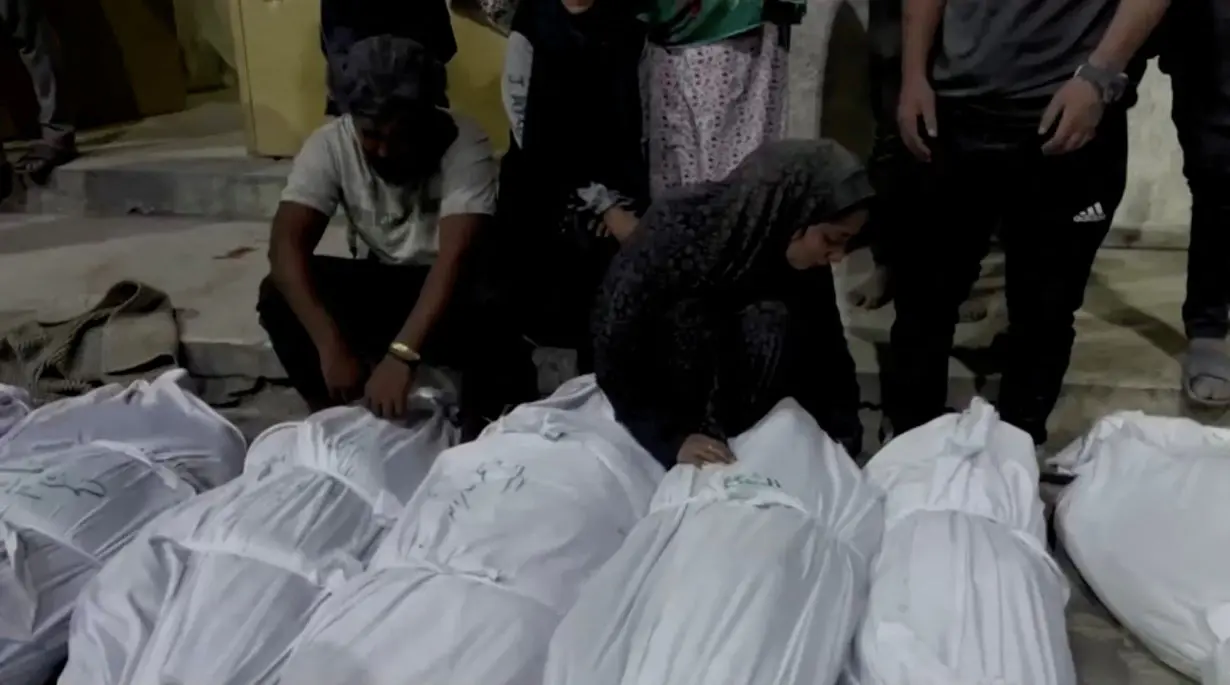 Mourners react next to the bodies of Palestinians killed in Israeli strikes at Kamal Adwan hospital in Jabalia, in the northern Gaza Strip in this still image taken from a video on Sunday.