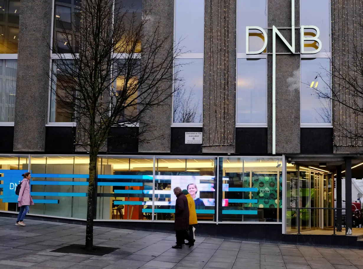 People walk past DNB bank branch in Stavanger