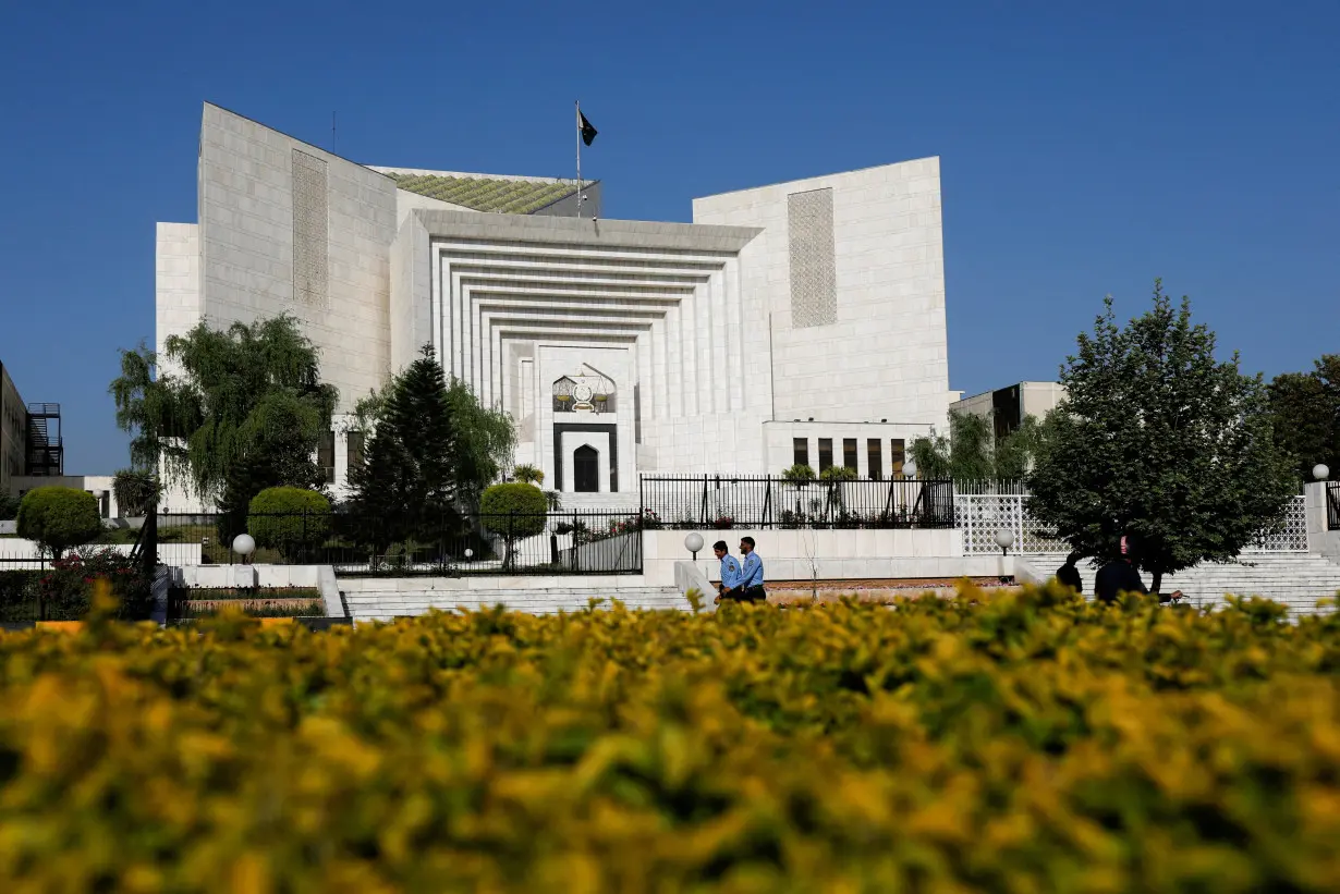 FILE PHOTO: Police officers walk past the Supreme Court of Pakistan building, in Islamabad,