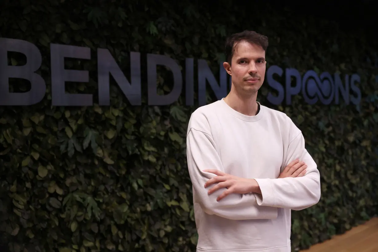 Bending Spoons CEO Luca Ferrari poses with the company logo in Milan