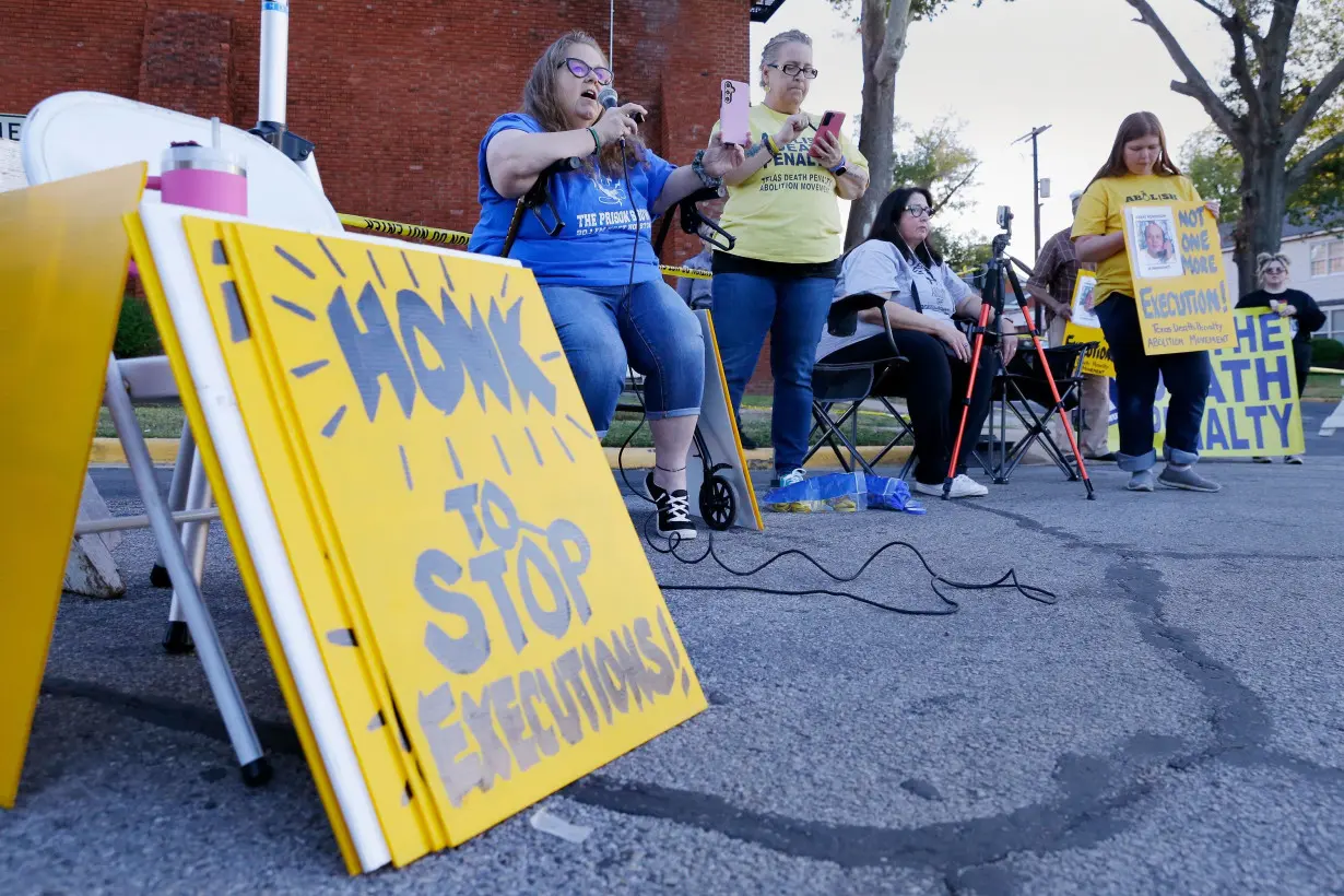 Dani Allen, center left with microphone, an anti-death penalty advocate, speaks during a protest outside the prison where Robert Roberson was scheduled for execution on October 24 in Huntsville, Texas.