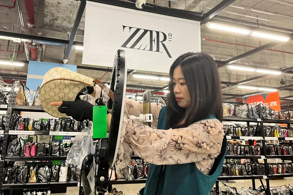 FILE PHOTO: Livestreamer promotes a bag at the ZZER warehouse in Shanghai