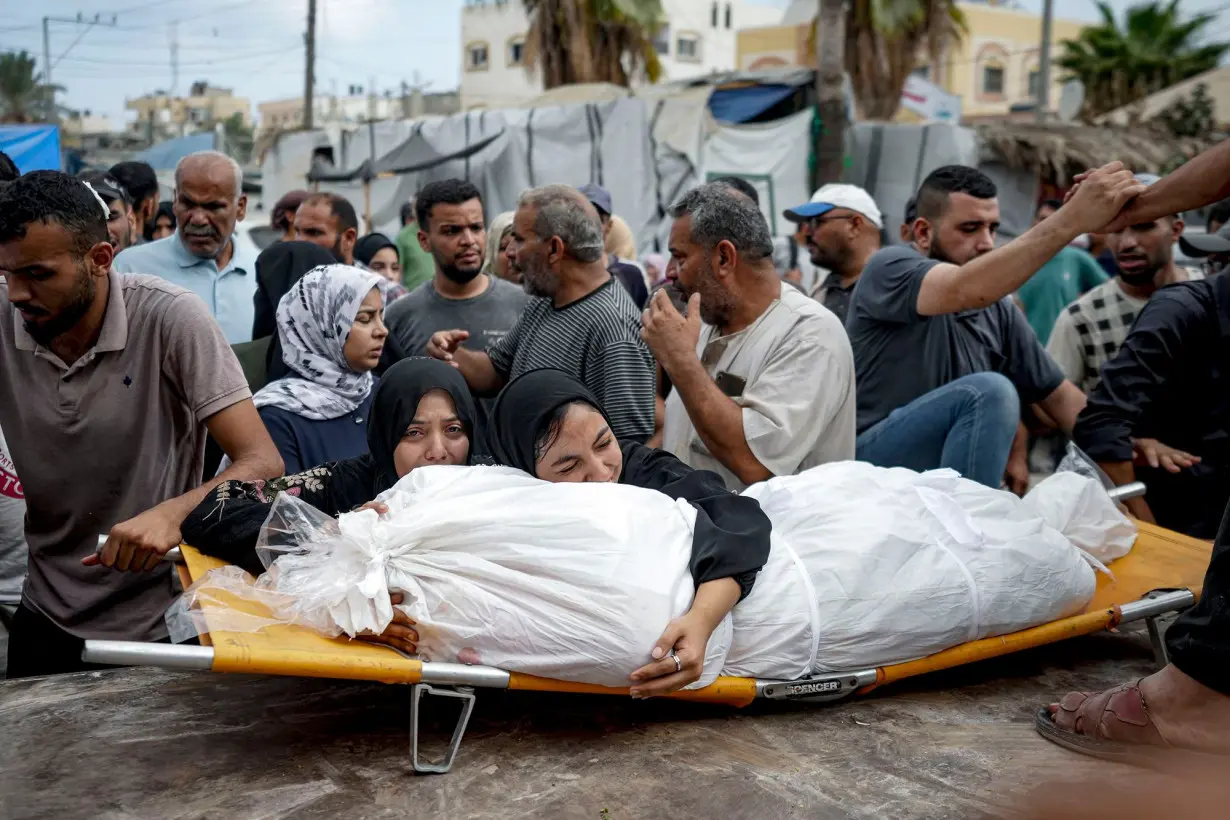 Palestinian women mourn a relative killed in Israeli bombardment of the Gaza Strip, at a hospital in Deir al-Balah on March 22.