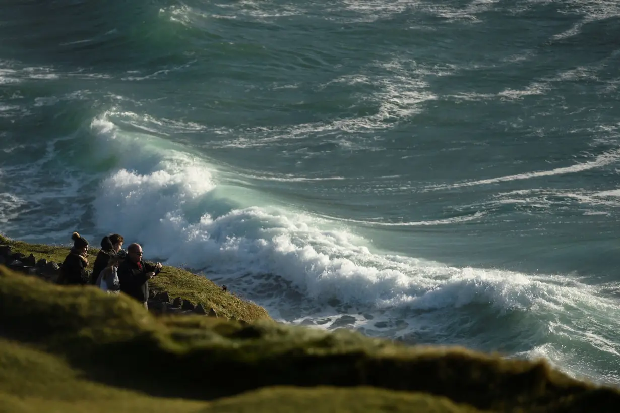 FILE PHOTO: People look out to the Atlantic ocean from Slea Had in Ventry