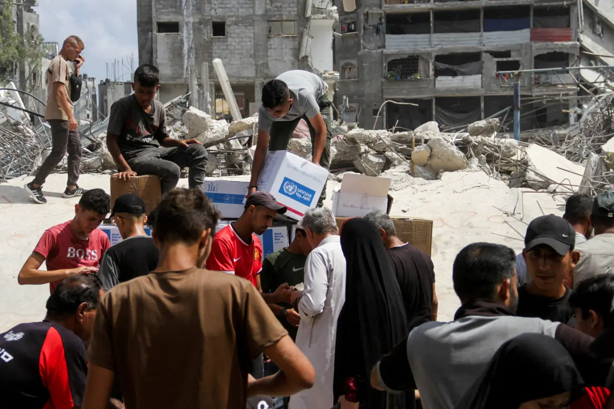 FILE PHOTO: Palestinians gather to receive aid, in Jabalia, northern Gaza Strip