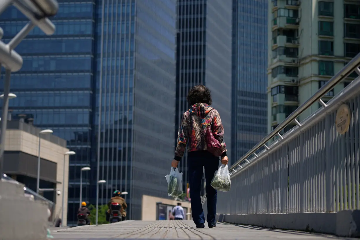 A woman walks on a bridge in Shanghai