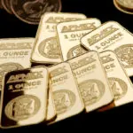 Gold hovers near record high on safe-haven demand