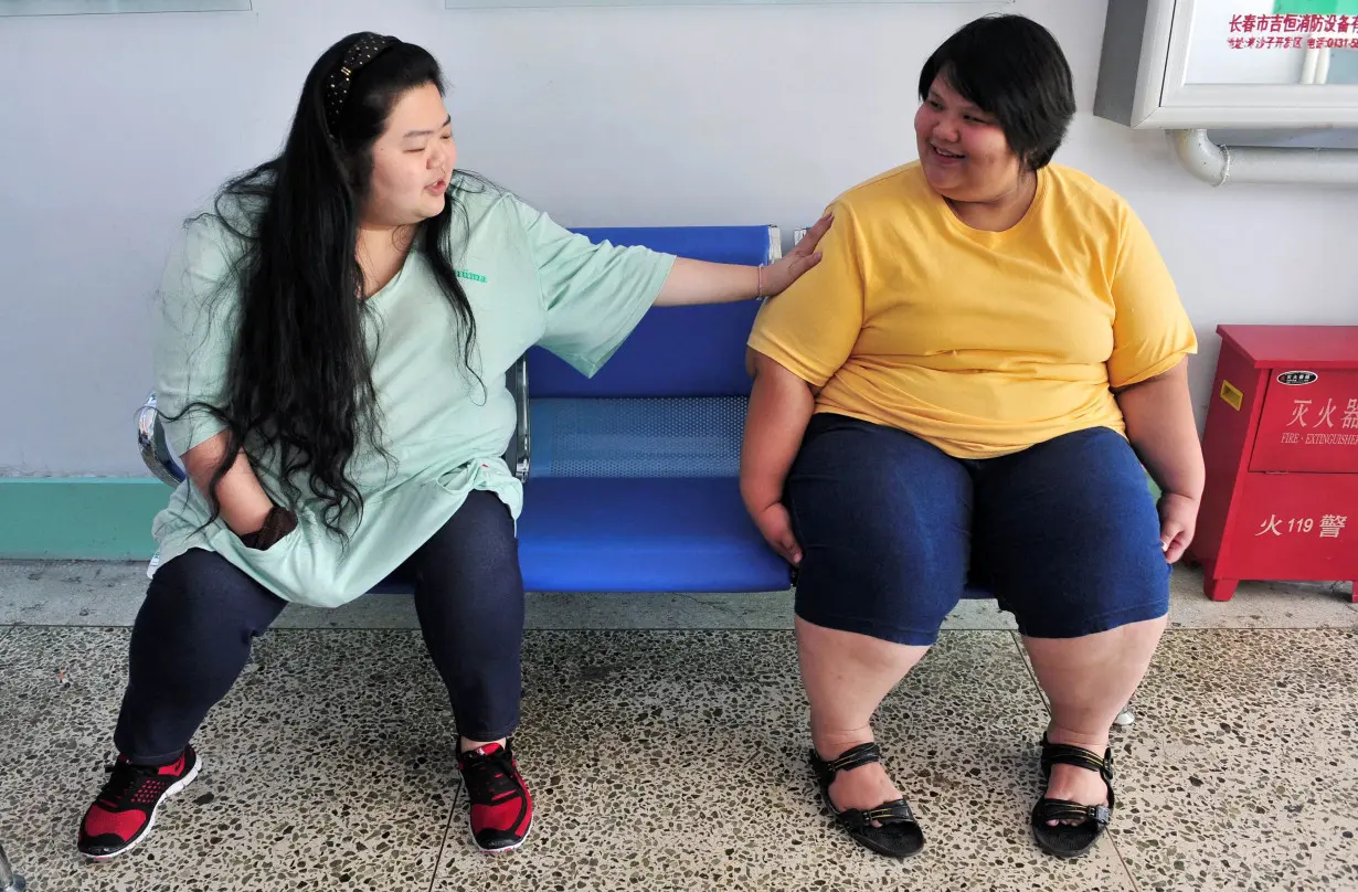 FILE PHOTO: Patients chat with each other at a weight loss centre in Changchun