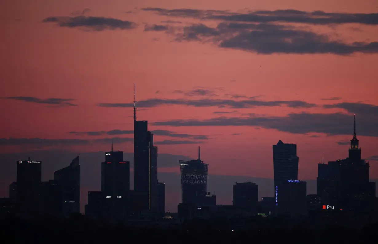 Skyline of skyscrapers is seen after sunset in Warsaw