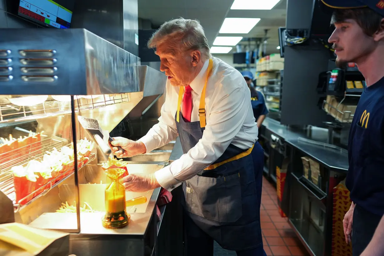 Former President Donald Trump works behind the counter during a visit to a McDonald's restaurant on October 20, in Feasterville-Trevose, Pennsylvania.