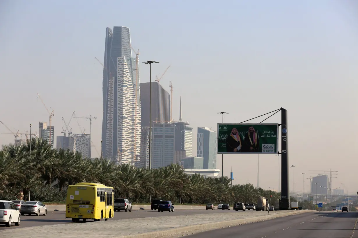 Cars drive past the King Abdullah Financial District in Riyadh