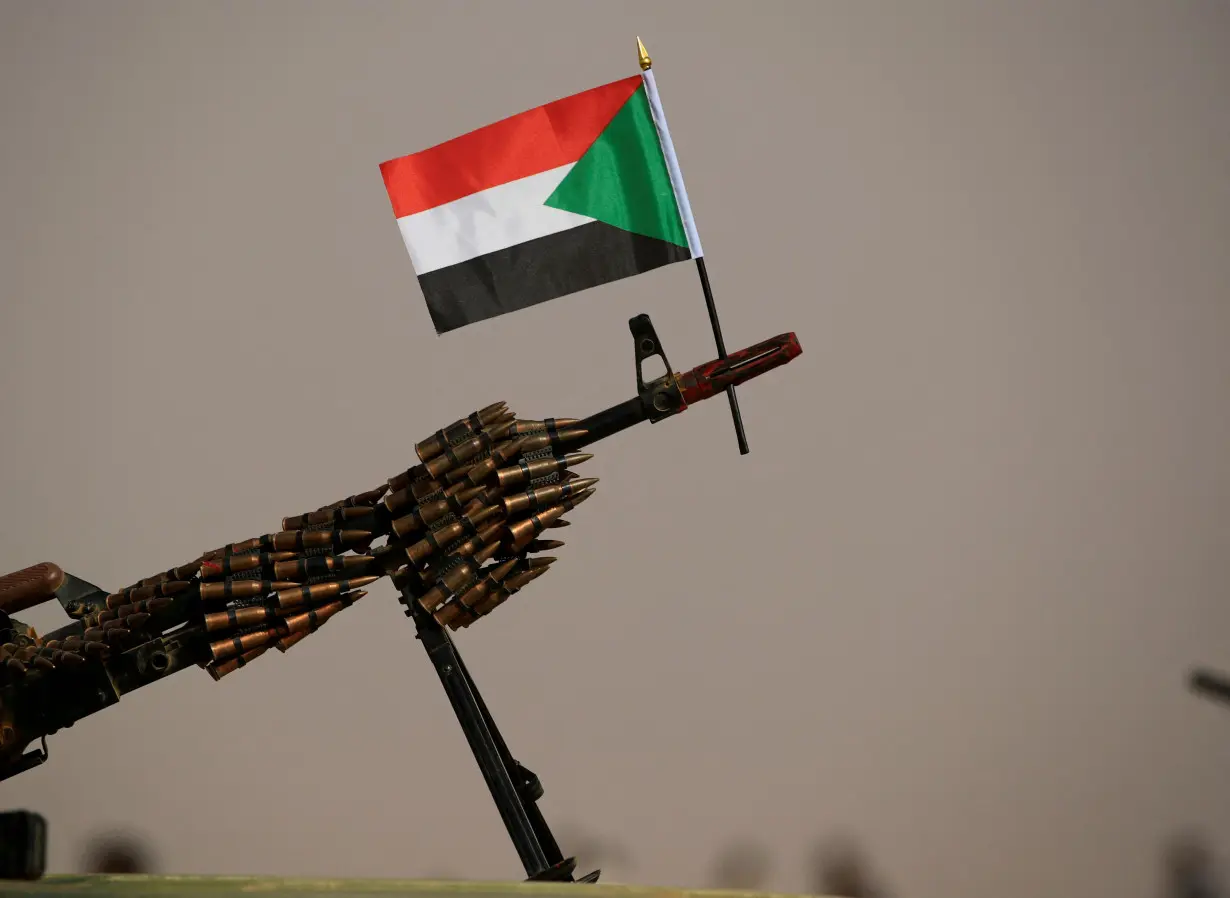 A Sudanese national flag is attached to a machine gun of Paramilitary Rapid Support Forces (RSF) soldiers as they wait for the arrival of Lieutenant General Mohamed Hamdan Dagalo before a meeting