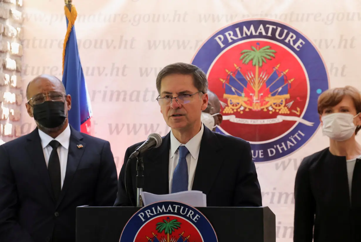 Haiti's Prime Minister Ariel Henry and World Bank Vice President for the Latin America and the Caribbean Region Carlos Felipe Jaramillo address the audience, in Port-au-Prince