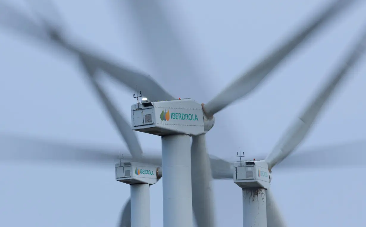 The logo of Spanish utilities company Iberdrola is displayed on wind turbines at Mt. Oiz