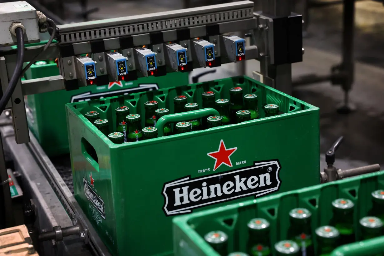 Crates of beer move along the conveyor belt at the Heineken brewery in Zoeterwoude