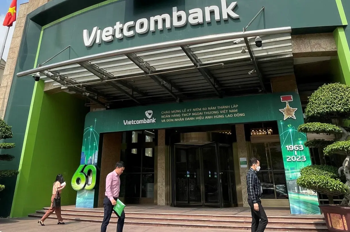 People walk in front of the Vietcombank Headquarters in Hanoi